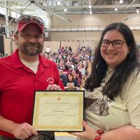 Paul Arnold recieves Patricia Behring Teacher of the Year Award from Danielle Griego